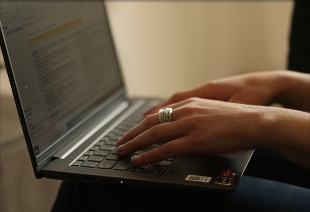 Close up of Roberta's hands typing on her laptop.