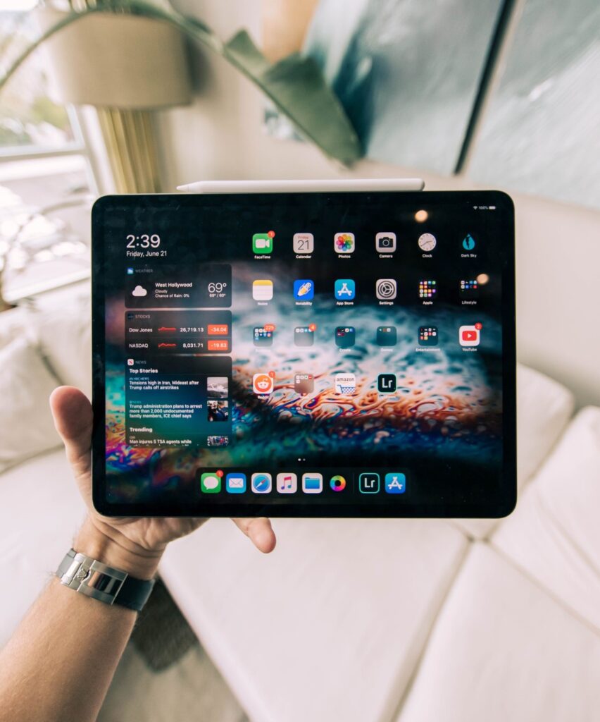 Hand holding a tablet.