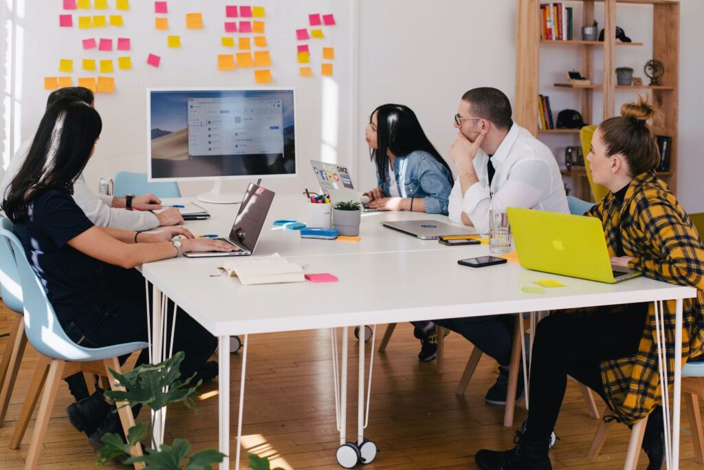 A group of people sitting at a desk.