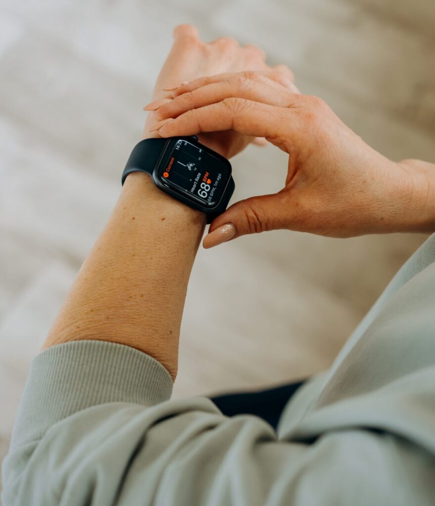 Close up of a woman's arm who is touching her smartwatch.