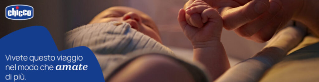 Banner per il brand Chicco. Un bambino appena nato tiene in mano il dito di una mano adulta. Il claim recita: "Vivete questo viaggio nel modo che amate di più".